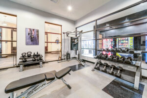 Fitness center with dumbells benches and kettlebells
