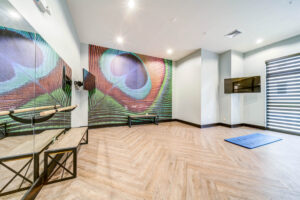 Fitness center yoga room with barre