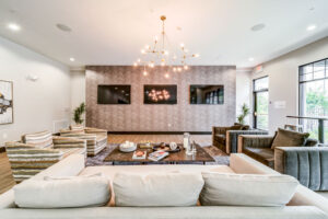 Seating area of clubroom with chairs sofa and TV