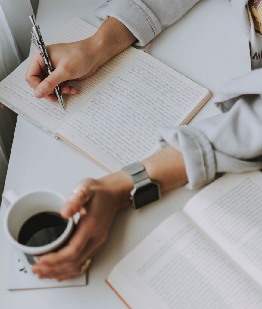 Taking notes and drinking coffee